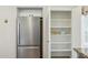A stainless steel refrigerator and shelved pantry offer ample storage in this kitchen at 20218 N 33Rd Pl, Phoenix, AZ 85050