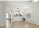 Bright living space showing archway to the kitchen with a chandelier and tile flooring at 20218 N 33Rd Pl, Phoenix, AZ 85050