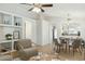 Bright, open-concept living and dining area with tile flooring and built-in shelving offers a cozy seating arrangement at 20218 N 33Rd Pl, Phoenix, AZ 85050