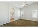 The main bedroom offers an ensuite bathroom, neutral walls, and a ceiling fan at 20218 N 33Rd Pl, Phoenix, AZ 85050