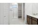 Bright bathroom featuring a marble shower, shelving, and neutral paint creating a clean and modern design at 25606 N 154Th Ln, Surprise, AZ 85387