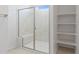 Beautiful shower featuring marble, glass door, and shelving, enhancing the clean and modern design at 25606 N 154Th Ln, Surprise, AZ 85387
