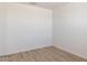 Empty bedroom showcasing neutral walls and wood-look floors, providing a blank canvas at 25606 N 154Th Ln, Surprise, AZ 85387