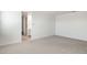Bedroom with plush carpet and an open doorway to a bathroom at 25606 N 154Th Ln, Surprise, AZ 85387