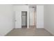 Bedroom with neutral carpet and white walls with a closet and entry doorway at 25606 N 154Th Ln, Surprise, AZ 85387