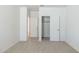 Bright bedroom with neutral carpet and white walls with a closet and entry doorway at 25606 N 154Th Ln, Surprise, AZ 85387
