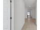Inviting hallway with neutral paint, tile flooring, and an open floor plan, ideal for easy navigation throughout the home at 25606 N 154Th Ln, Surprise, AZ 85387