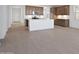 Spacious open area, featuring a modern kitchen island with stainless appliances and generous tile flooring at 25606 N 154Th Ln, Surprise, AZ 85387