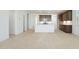 Open-concept space showcasing tile floors, modern kitchen with an island, and bright lighting at 25606 N 154Th Ln, Surprise, AZ 85387