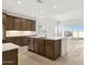 Bright kitchen featuring stainless steel appliances, a large island, modern cabinets and tile floors at 25606 N 154Th Ln, Surprise, AZ 85387