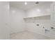 Well-lit laundry room features tile flooring and ample storage space at 25606 N 154Th Ln, Surprise, AZ 85387
