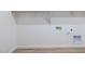 Clean, white laundry room area with hookups and overhead shelving at 25606 N 154Th Ln, Surprise, AZ 85387