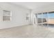 Bright and airy living area with tile flooring, large sliding glass doors and natural light at 25606 N 154Th Ln, Surprise, AZ 85387