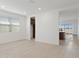 Bright and open floor plan with ceramic tile, natural light, and view into kitchen at 25606 N 154Th Ln, Surprise, AZ 85387