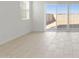 Bright living room with sliding glass doors to backyard and ceramic tile flooring at 25606 N 154Th Ln, Surprise, AZ 85387