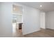 Bright living room boasts sleek flooring, neutral walls, and an open layout into kitchen at 25606 N 154Th Ln, Surprise, AZ 85387