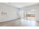Bright living room boasts sleek flooring, neutral walls, and sliding door to patio at 25606 N 154Th Ln, Surprise, AZ 85387