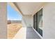 Covered patio with sliding glass doors that opens to a spacious backyard at 25606 N 154Th Ln, Surprise, AZ 85387
