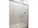 Modern walk-in shower with marble-look tile surround and glass door at 25606 N 154Th Ln, Surprise, AZ 85387