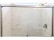 Contemporary shower featuring marble-look tile and a sleek glass door at 25606 N 154Th Ln, Surprise, AZ 85387