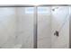 Bright and spacious shower featuring marble-style wall with a small window above sliding glass doors at 25606 N 154Th Ln, Surprise, AZ 85387