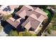 Property aerial showcasing a large tile roof, backyard putting green, and proximity to neighborhood amenities at 30227 N 124Th Dr, Peoria, AZ 85383