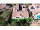Large backyard featuring artificial turf, covered patio, and a swimming pool, surrounded by mature landscaping and privacy fencing at 30227 N 124Th Dr, Peoria, AZ 85383