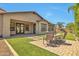 Outdoor seating area with manicured lawn and hardscape, offering an inviting space for entertaining and relaxation at 30227 N 124Th Dr, Peoria, AZ 85383