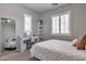 Stylish bedroom featuring a desk, full length mirror, plush carpet, and abundant natural light, perfect for comfort and productivity at 30227 N 124Th Dr, Peoria, AZ 85383