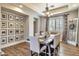 Elegant dining room with a rustic wood table, neutral chairs, and curated wall art at 30227 N 124Th Dr, Peoria, AZ 85383