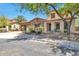 Beautiful desert home with stone accents, covered entryway, and mature landscaping creating a serene curb appeal at 30227 N 124Th Dr, Peoria, AZ 85383