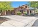 Charming home featuring a stone facade, landscaped front yard, and a spacious driveway leading to a two-car garage at 30227 N 124Th Dr, Peoria, AZ 85383