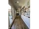 Hallway with wood floors, backyard view, and decorative wall art at 30227 N 124Th Dr, Peoria, AZ 85383