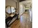 Inviting hallway with elegant wood flooring and decorative accents, leading to multiple rooms with natural light at 30227 N 124Th Dr, Peoria, AZ 85383