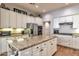 Spacious kitchen features white cabinetry, granite countertops, stainless steel appliances, and center island at 30227 N 124Th Dr, Peoria, AZ 85383