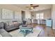Cozy living room with plush gray sofa, decorative wall art, and built-in desk area, perfect for relaxation and productivity at 30227 N 124Th Dr, Peoria, AZ 85383