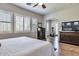Bright bedroom with plantation shutters and wood floors leading to an exercise room at 30227 N 124Th Dr, Peoria, AZ 85383