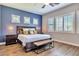 Large bedroom features wood floors, blue accent wall, many windows with plantation shutters at 30227 N 124Th Dr, Peoria, AZ 85383