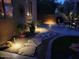 Backyard features a stone pathway, lush landscaping, and warm lighting, creating a serene outdoor retreat at 32795 N Hidden Canyon Dr, San Tan Valley, AZ 85144