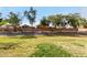 View from behind a block wall to the rear of other properties across a grassy greenbelt at 32795 N Hidden Canyon Dr, San Tan Valley, AZ 85144
