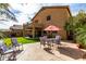Spacious backyard with flagstone patio, seating area, lush lawn, and a second story balcony at 32795 N Hidden Canyon Dr, San Tan Valley, AZ 85144