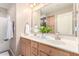 Bright bathroom featuring double sinks, vanity storage, large mirror, and shower-tub combo for relaxation at 32795 N Hidden Canyon Dr, San Tan Valley, AZ 85144