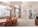 Spacious dining room with high ceilings, ample natural light, and large table, perfect for gatherings and entertaining at 32795 N Hidden Canyon Dr, San Tan Valley, AZ 85144
