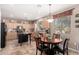 Well-lit kitchen featuring stainless steel appliances, center island, tile flooring, and a cozy dining area with a chandelier at 32795 N Hidden Canyon Dr, San Tan Valley, AZ 85144