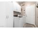 Convenient laundry room with washer, dryer, cabinets, and utility sink at 32795 N Hidden Canyon Dr, San Tan Valley, AZ 85144