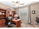 Functional home office equipped with custom built-ins, natural light, and ample workspace for productivity and organization at 32795 N Hidden Canyon Dr, San Tan Valley, AZ 85144