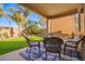 Relaxing covered patio with comfortable seating, perfect for outdoor dining and entertaining at 32795 N Hidden Canyon Dr, San Tan Valley, AZ 85144
