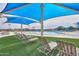 Relaxing poolside lounge area with comfortable seating and a large shade structure overlooking the community pool at 32795 N Hidden Canyon Dr, San Tan Valley, AZ 85144