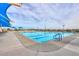Large community swimming pool with clear blue water, lap lanes, and shaded lounging areas for residents at 32795 N Hidden Canyon Dr, San Tan Valley, AZ 85144