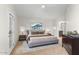 Staged primary bedroom with a platform bed, neutral decor, and an ensuite bathroom entrance at 4220 E Everett Dr, Phoenix, AZ 85032